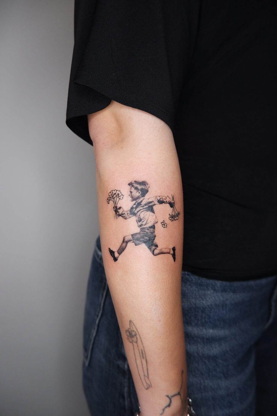 running boy with flowers tattoo